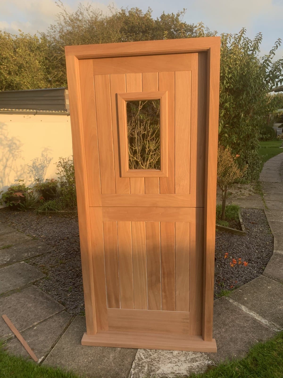 Hand-built oak stable door standing in golden-hour evening light