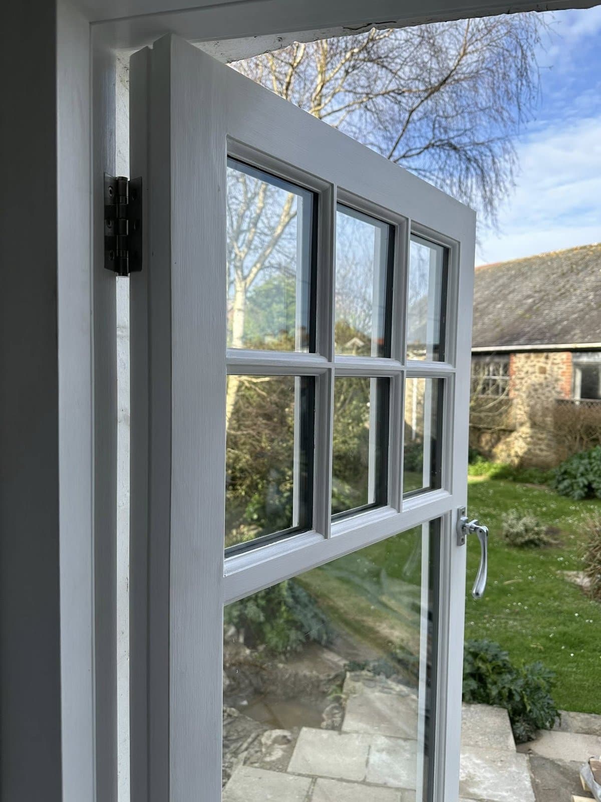 Bespoke timber sash window in a traditional Devon cottage — view from inside looking out to garden