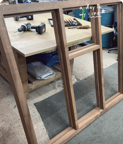 Walnut bay window mid-build on the workshop bench with 'a day in my life' caption — TikTok video thumbnail with 8,529 views