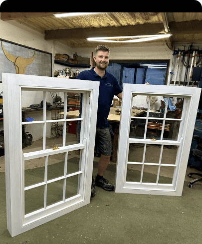 Two finished white-painted sash windows in the workshop — TikTok video thumbnail with 8,972 views